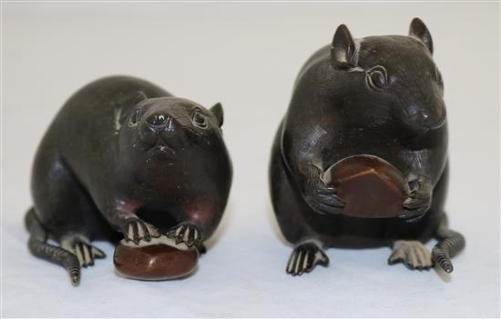 Two Japanese two-colour bronze models of a rat holding a nut, 19th century, length 9cm and 9.5cm